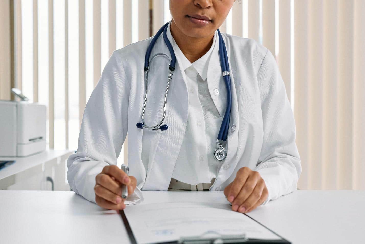 A doctor reading a form