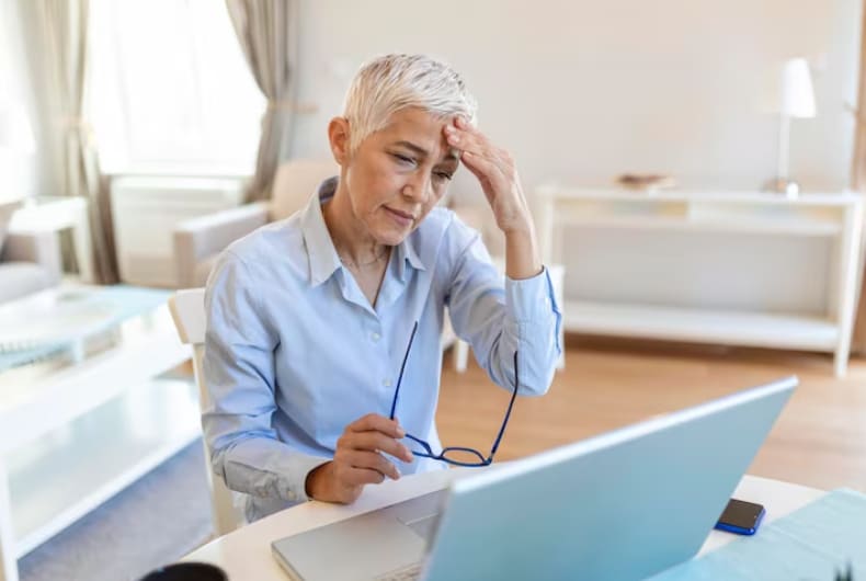 Employee experiencing migraine and light sensitivity at work representing need for FMLA leave