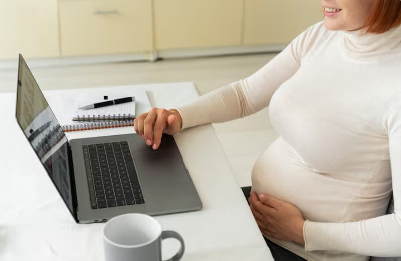Pregnant woman reviewing medical certification requirements for FMLA pregnancy leave documentation