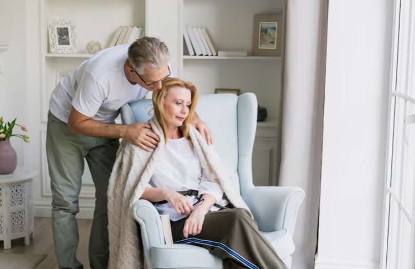 Stressed caregiver supporting elderly parent showing emotional burden and need for FMLA leave