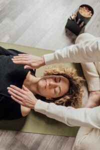 a woman lying on the floor having therapy.