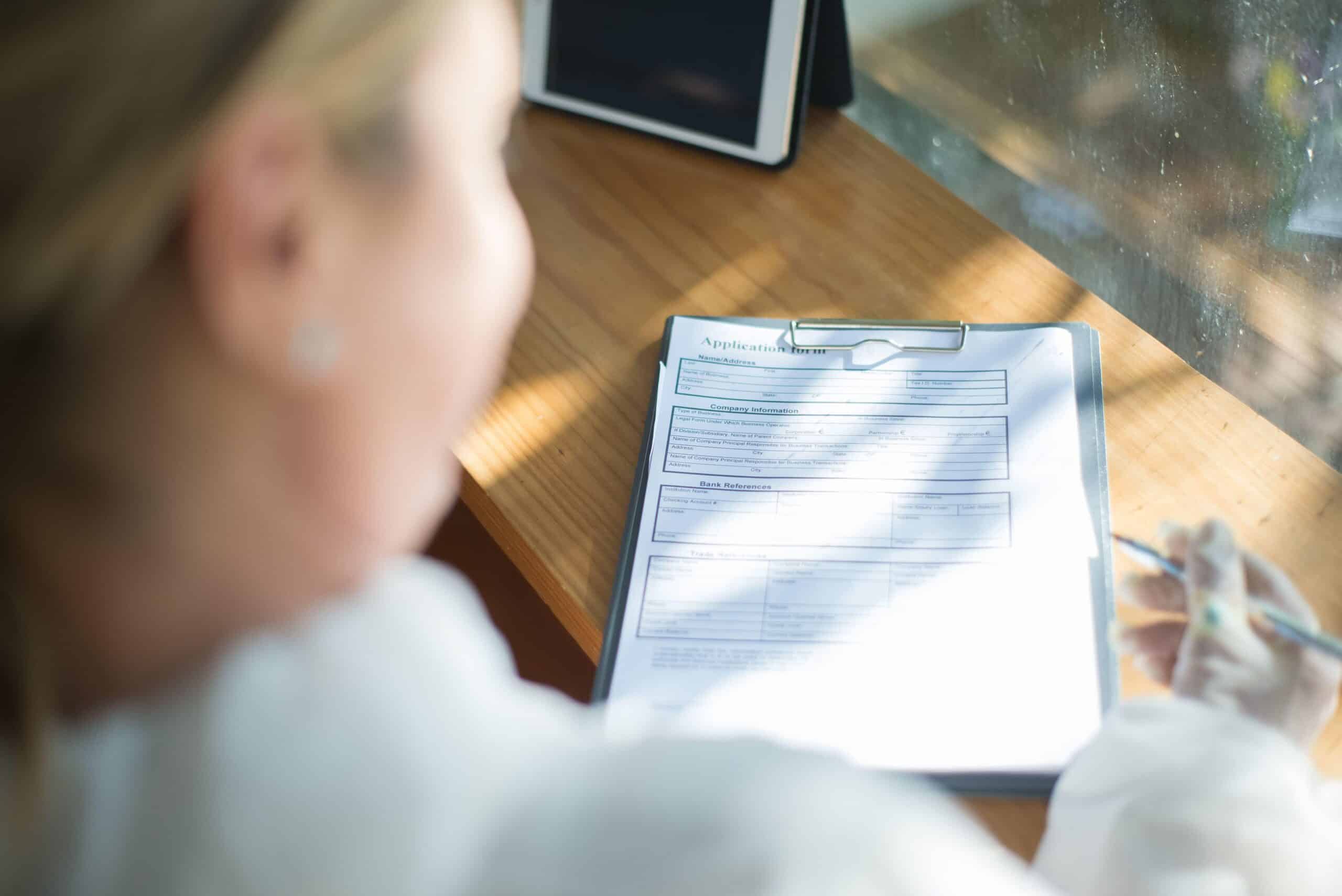 Employee reviewing an intermittent FMLA form with a pen while preparing leave documentation
