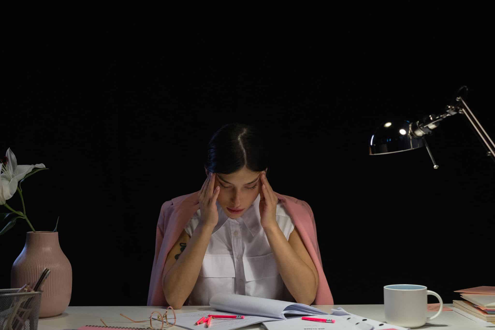 an exhausted person sitting at their seat at work