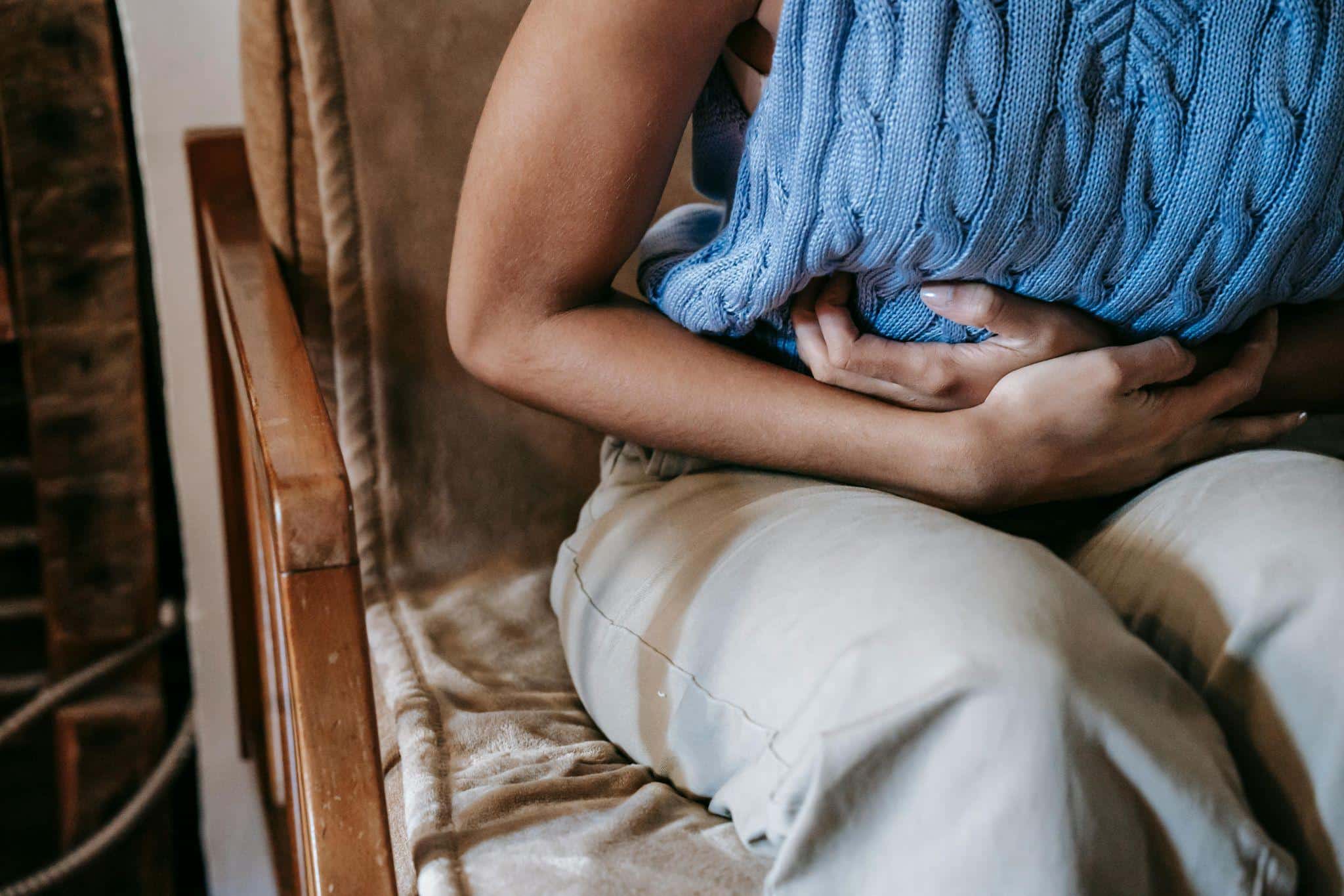 a woman holding her stomach in pain