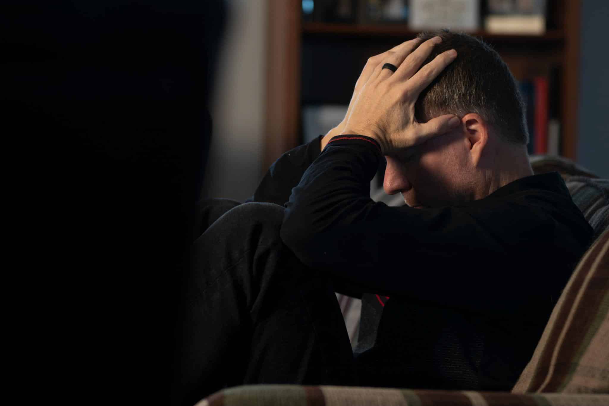 a person holding their head due to a headache
