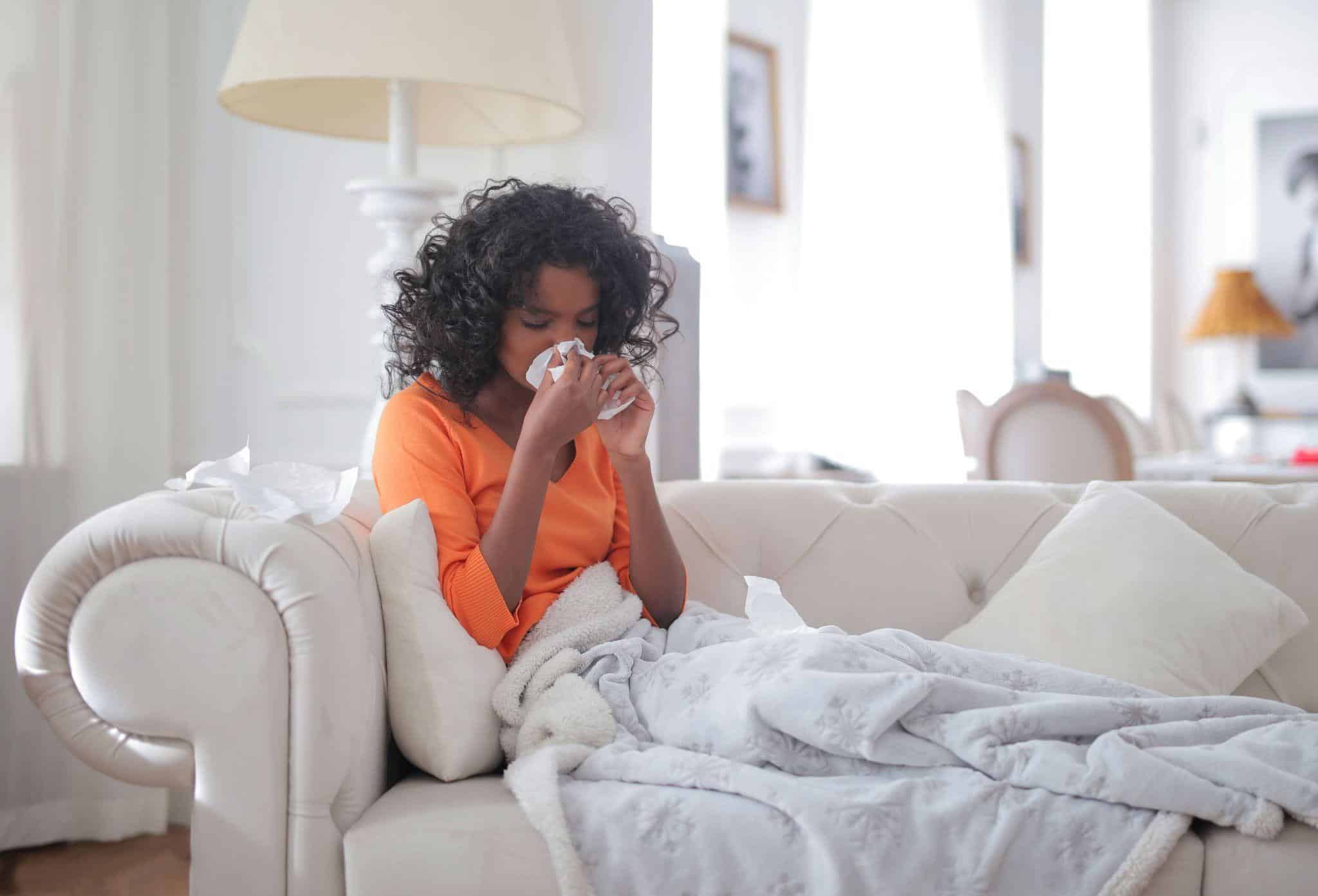 a sick person resting on a couch